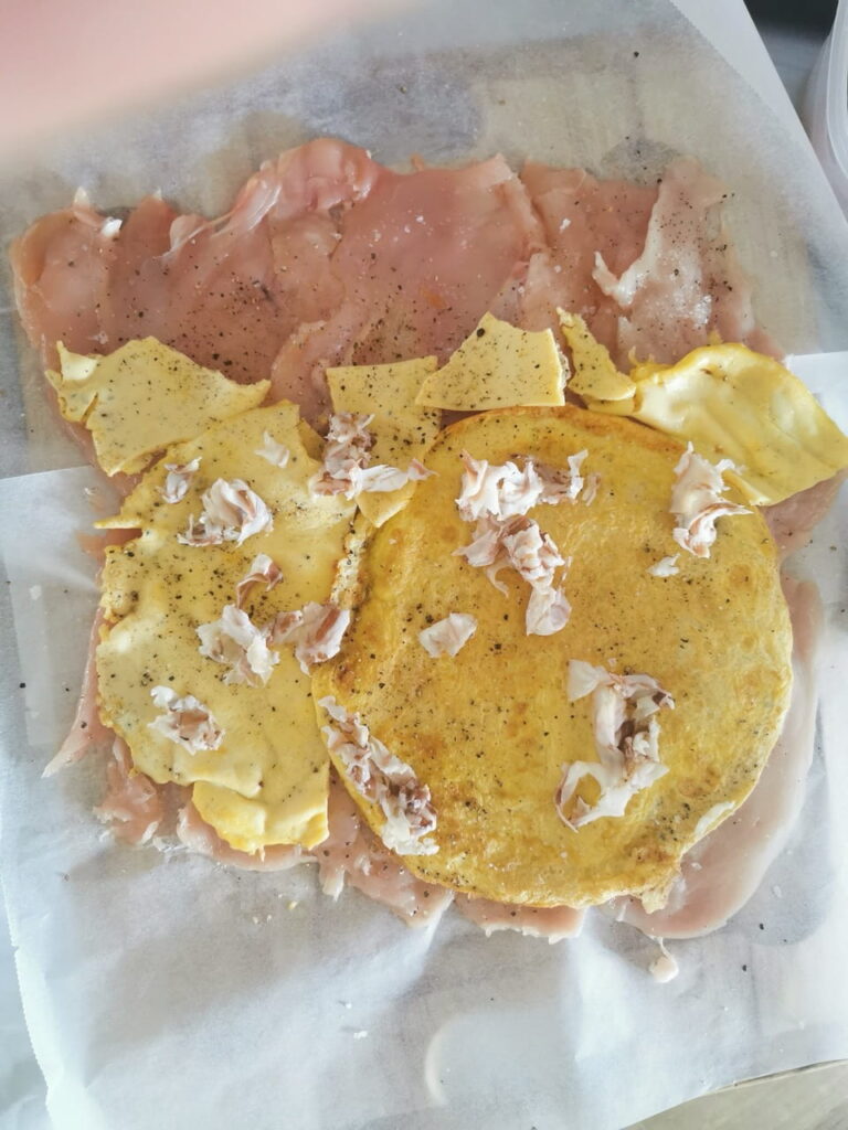 Rotolo mit Omelette und Schinken belegt.