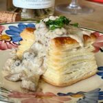 Veal sweetbread vol-au-vent on a plate garnished with fresh parsley
