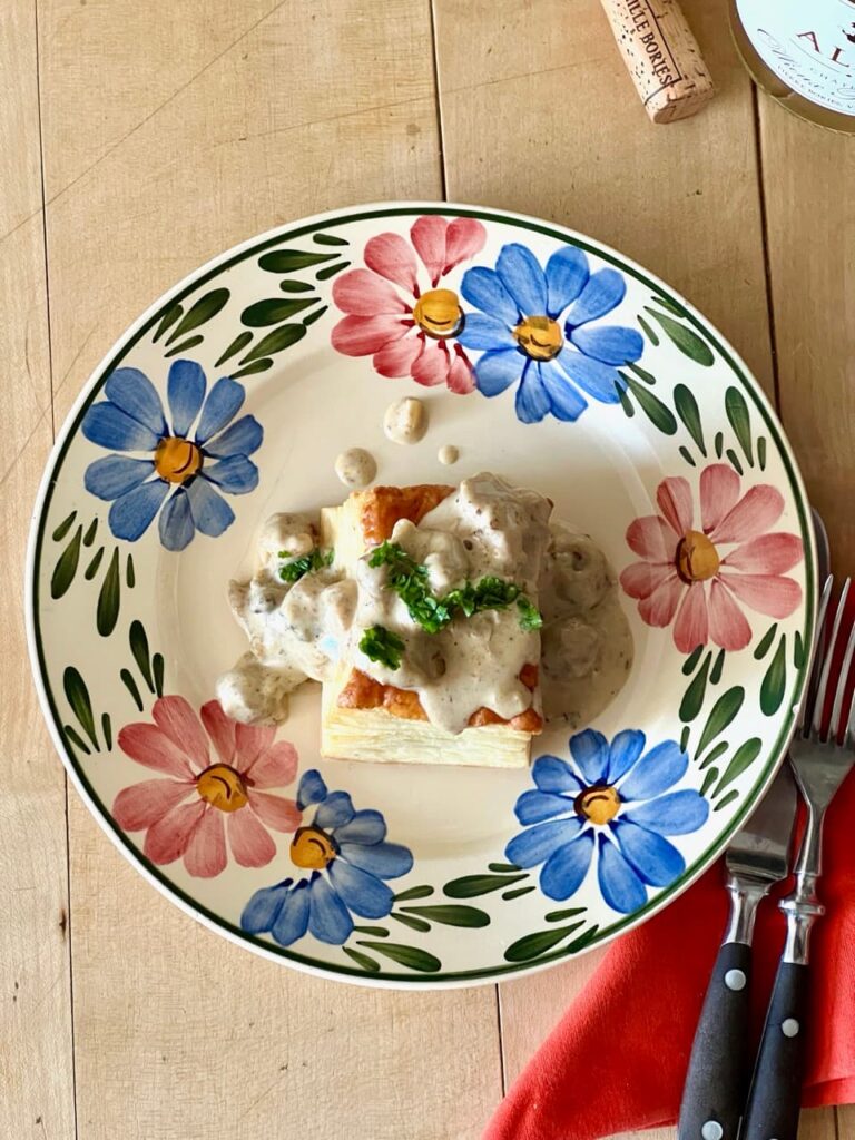 Veal sweetbread vol-au-vent on a plate garnished with fresh parsley