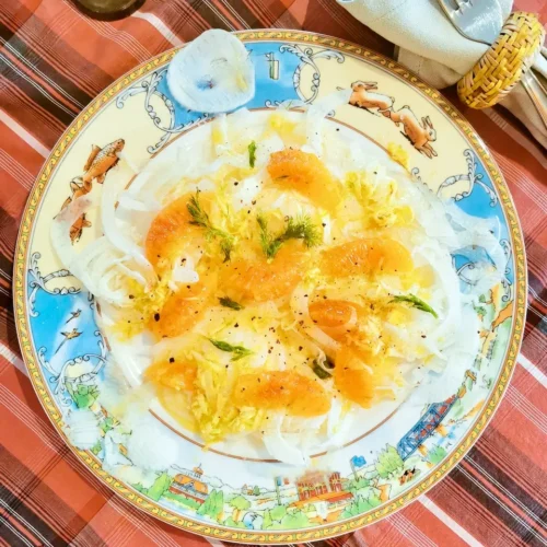 Fennel and orange salad with ginger, lime and orange segments on a flat plate