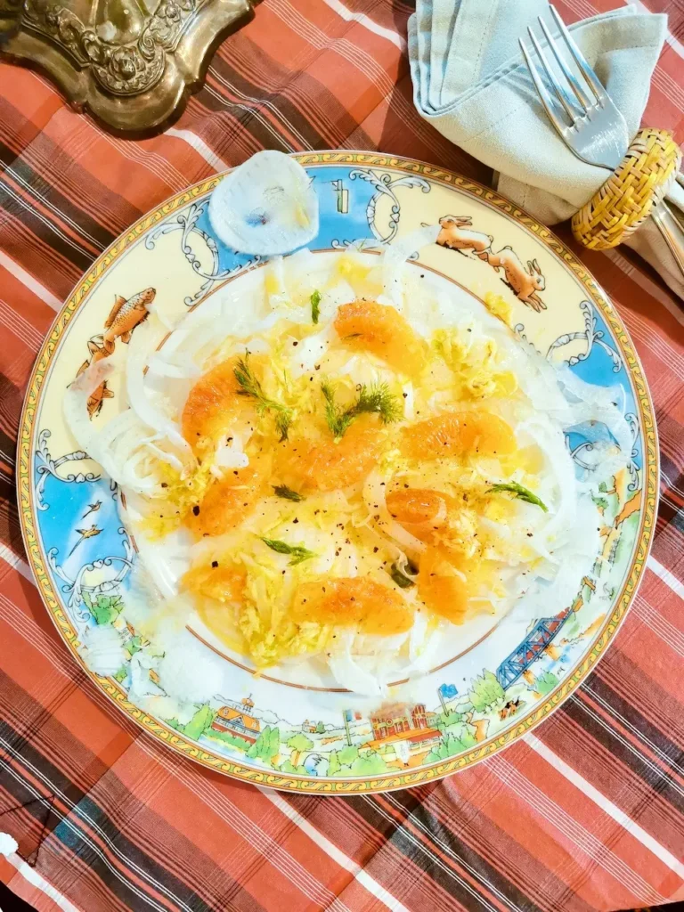 Fennel and orange salad with ginger, lime and orange segments on a flat plate