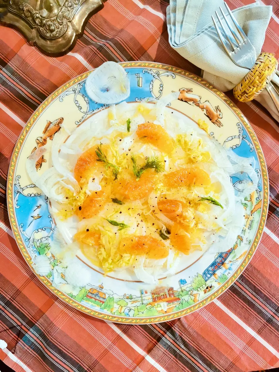 Ingredients for fennel and orange salad with fennel, oranges, lime and ginger on a plate.